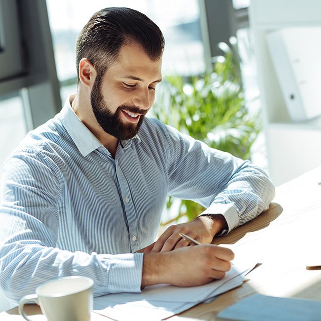 An image of an Industrial Services provider happily reviewing his marketing services.